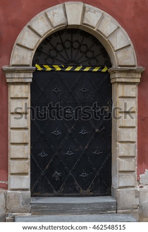 Old wrought iron door at the entrance to the building.