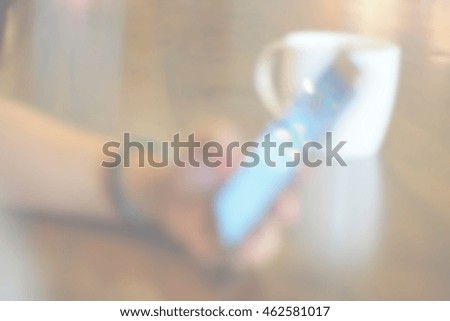 Blurred abstract background of use phone in coffee shop