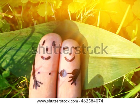 fingers represent loving couple sunbathing under the sun  close up photo