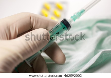 A doctor holding the  syringe in a hospital