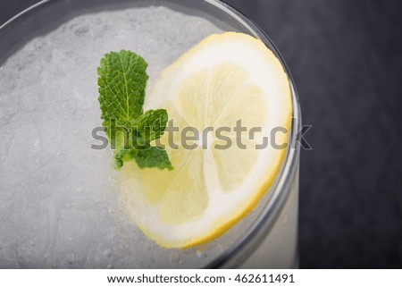 glass of mojito cocktail on black background