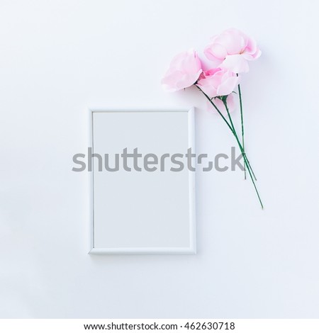 Empty picture frame with pink roses, top view