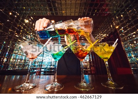 Barman show. Bartender pours alcoholic cocktails. Royalty-Free Stock Photo #462667129