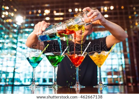 Barman show. Bartender pours alcoholic cocktails. Royalty-Free Stock Photo #462667138