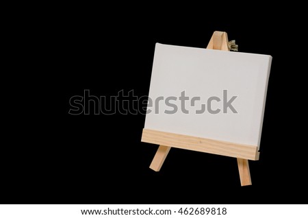 Blank canvas on easel for painting, Black background