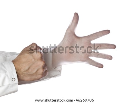 A doctor is putting on surgical latex gloves.
