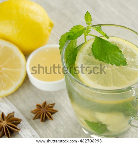 Ginger tea with mint and lemon on table