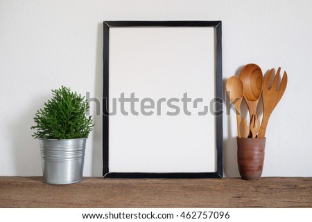 mock up  frame with plant pot and utensils on wooden shelf
