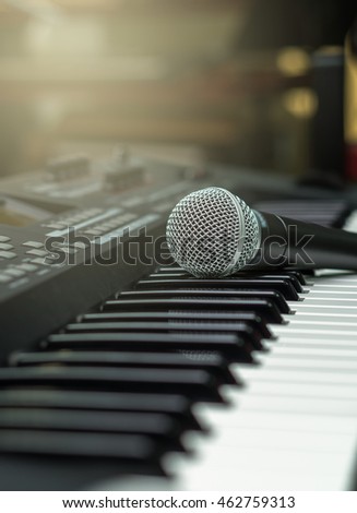 microphone on music keyboard with music brand blurred background, music instrument concept