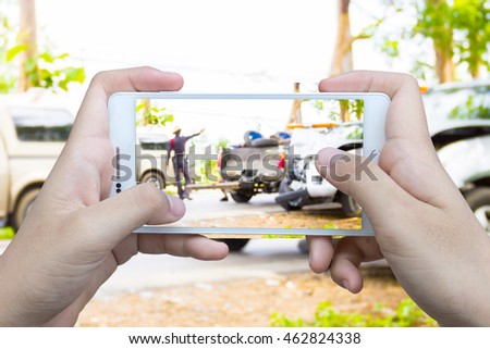 Girl use mobile phone , blur image of accident on the road as background.