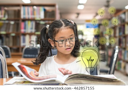 Innovative creative idea for copyrights law concept with kid reading book with lightbulb in library Royalty-Free Stock Photo #462857155