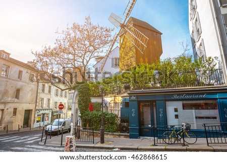 France. Paris. Moulin de la Galette. Streets of Montmartre in sunny autumn evening in backlit sunset sunbeam with vintage camera lense look. Royalty-Free Stock Photo #462868615