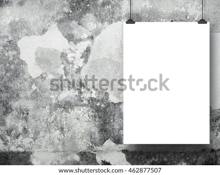 Close-up of one blank frame hanged by clips against gray weathered concrete wall background