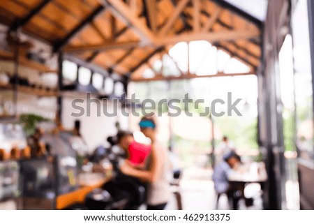 Blurred image of people sitting in cafe