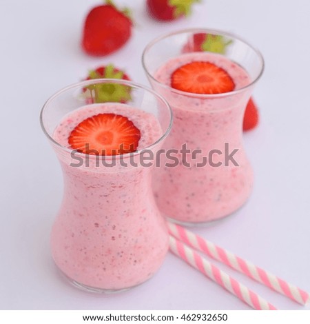 Strawberry smoothie in glass on white background