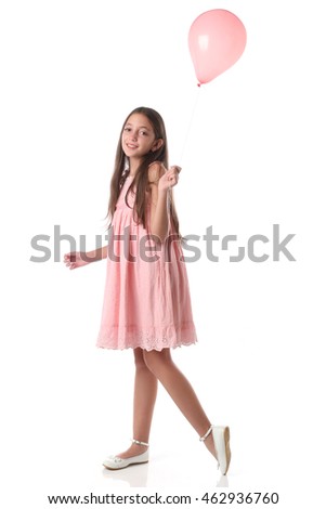 Lovely girl holding a pink balloon. Over white background. Love concept