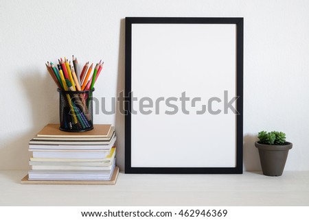mock up frame with stack of book and crayon . home office  decor
