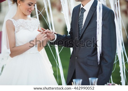 happy bride gives his husband a gold ring