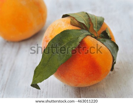 Fresh peaches on wood background