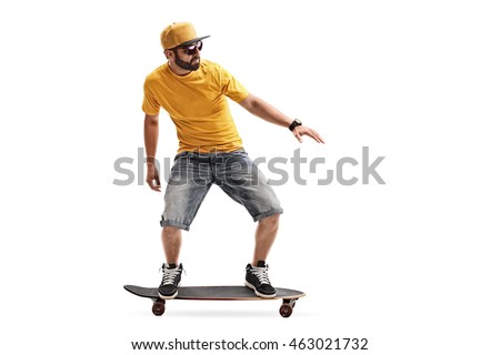 Studio shot of a cool young guy riding a skateboard isolated on white background