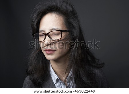 Close-up portrait of beautiful Asian Chinese woman with closed eyes , relaxing indoor

