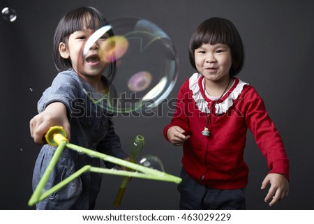 Two Asian Chinese child,Sisters and friends,playing in studio