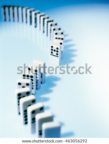 White dominoes in a row on blue ground
