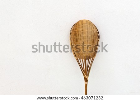 Image of strainer (small sieve) made from bamboo with handle on wood background.