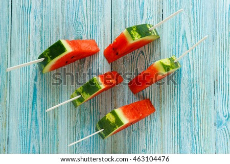 fresh slices of ripe watermelon at wooden background.