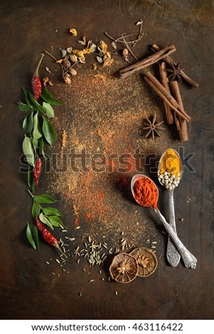 Various spices on black stone shot from aerial view