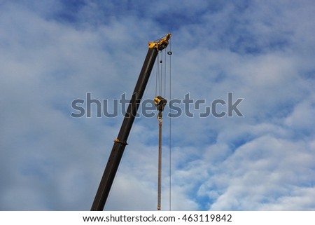 Crane and metal profile structure over blue sky photo
