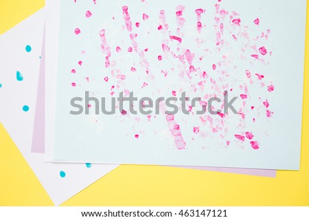 Abstract drop pink color on white paper on yellow background.
