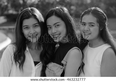 Black and white portrait of happy Asian teenager girls outdoors in park