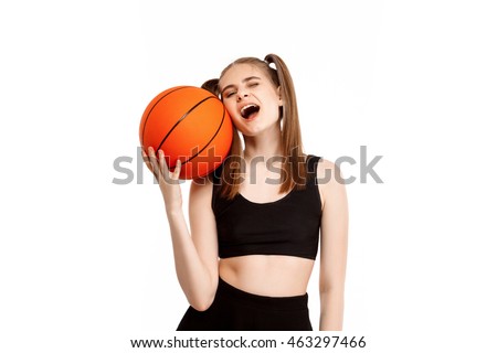 Young pretty girl posing with basketball, isolated on white background.