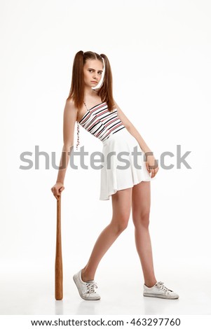 Young pretty girl posing with bat over white background.
