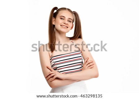 Young girl posing with crossed arms isolated on white background.