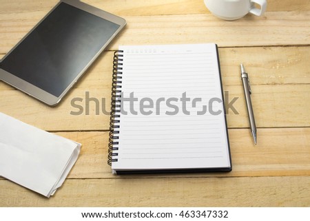 workplace with digital tablet, notebook and coffee cup