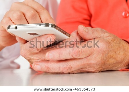 Picture of a senior woman hand using a smartphone