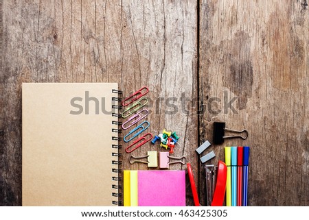 School supplies on old wooden background