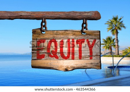Equity motivational phrase sign on old wood with blurred background
