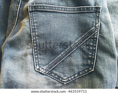Closeup front and back bag or pocket blue jeans vintage style texture background 