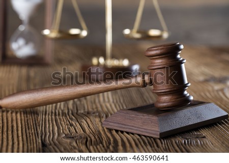 law theme, mallet of the judge, wooden desk, scales of justice, books, statue of justice and hourglass