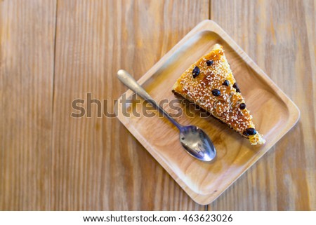 Chocolate cake topping with coconut flake and chocolate  chip on wooden tray and wooden table with flaring , top view picture
