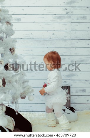 beautiful girl in costume standing near the Christmas tree