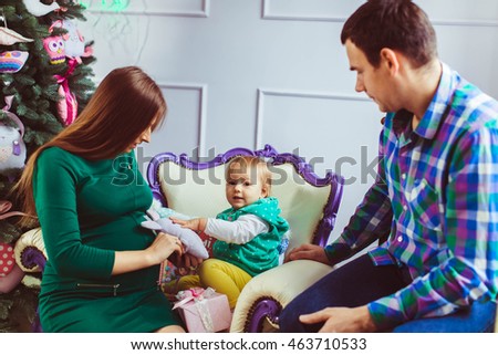 happy woman and her husband playing with baby