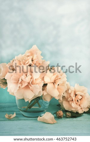 Beautiful rose flowers in a vase on a vintage background