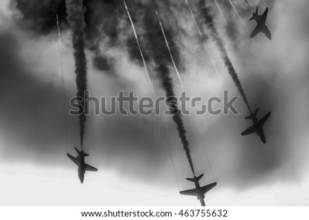 red arrows dramatically diving through a bank of clouds.