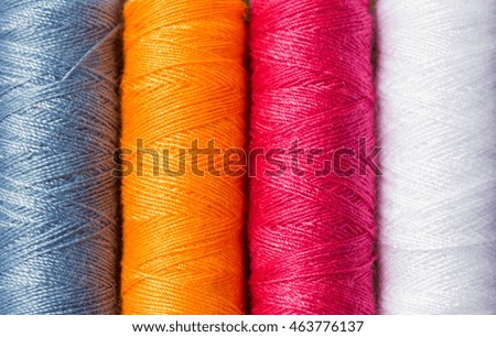variety of colors thread roll black background.