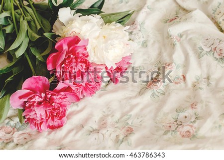 beautiful colorful peony bouquet on floral bed in the morning, sweet romantic moment , space for text