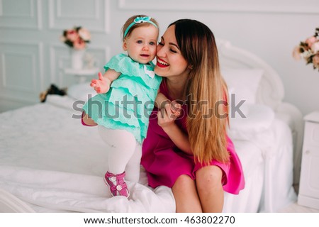 Mother and baby closeup portrait, happy faces, european family picture, adorable small girl, mom and kid having fun indoor, parents joy, healthy toddler and mommy, happiness concept